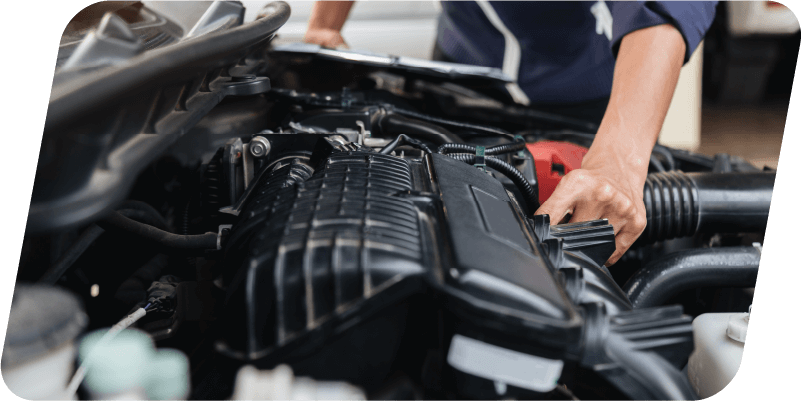 A mechanic looking into an engine