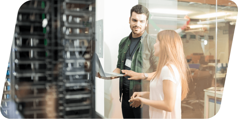 Two people talking in a server room